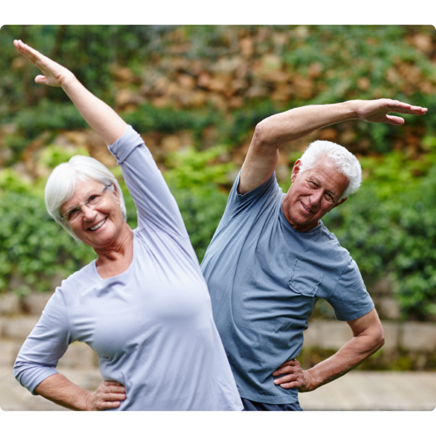 Retired Couple Stretching Overhead Outdoors