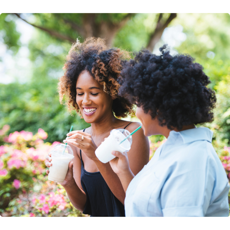Women Enjoying Smoothies Outdoors